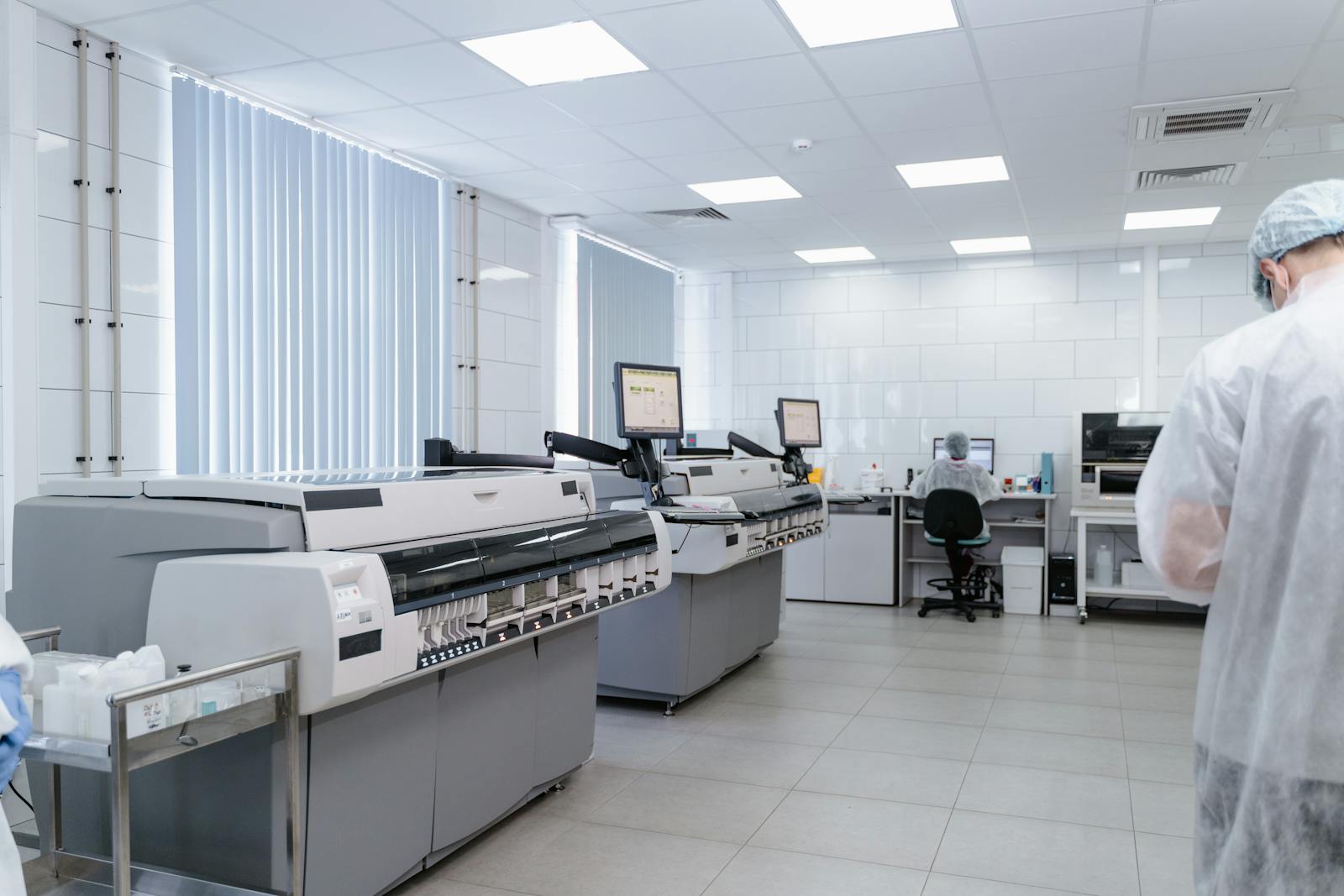 Bright and sterile laboratory featuring high-tech research equipment and professionals at work.
