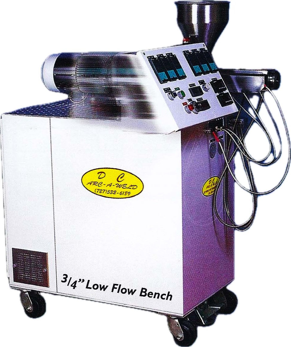 Industrial machine on wheels with control panel and attached wires. Label reads "D_C Arc-a-Weld" and "3/4” Low Flow Bench." Utilitarian and technical.